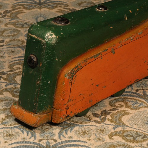 108 - **LOT WITHDRAWN** Folk Art - a 1930's painted wooden carpet toy, in the form of a streamlined locomo... 