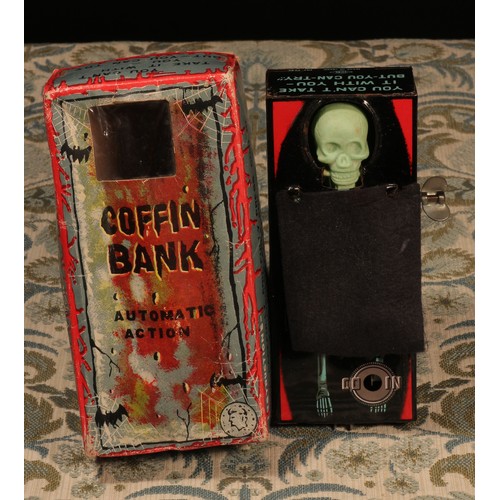 115 - A 1960's Japanese tinplate and plastic fixed key wind novelty Coffin Bank moneybox, in the form of a... 