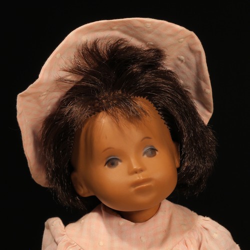 131 - A Götz Sasha Morgenthaler baby doll with dark brown hair, wearing a pink and white dress with underc... 