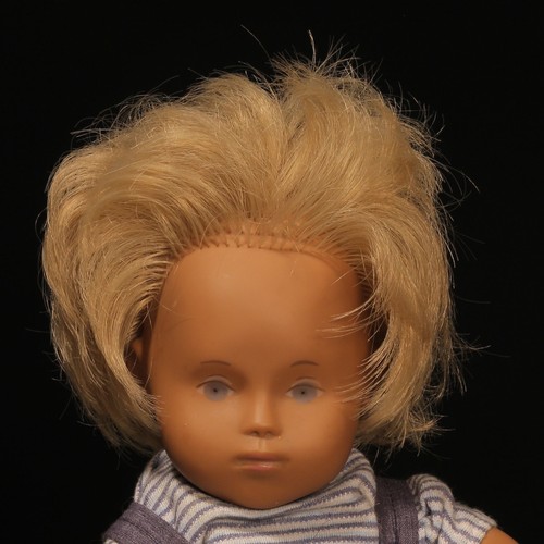 134 - A Götz Sasha Morgenthaler baby doll with blonde hair, wearing a pair of blue 'denim' type dungarees ... 