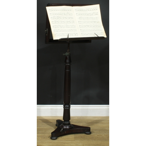 2176 - A 19th century mahogany music stand, turned column, incurve triform base, bun feet, 113cm raising to... 