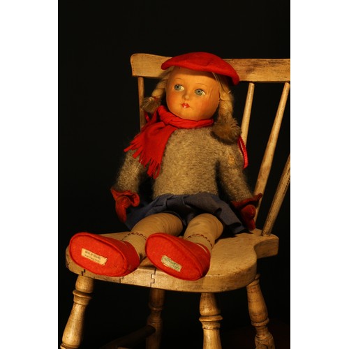 175 - A Dean's Rag Book Co cloth doll, the pressed moulded felt face with painted features including blue ... 