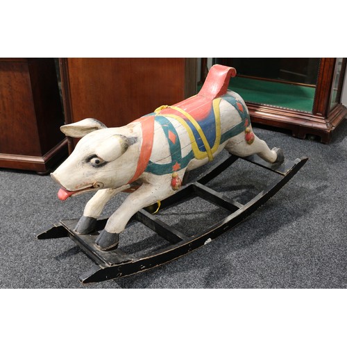 179 - Folk Art - a carved and painted wooden rocking Pig, the carved and painted Pig with pricked ears, th... 