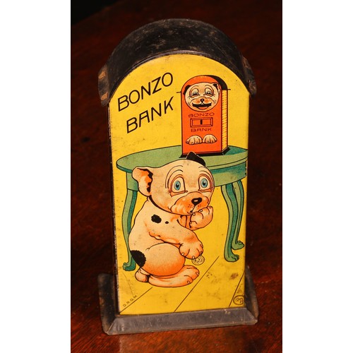 218 - A 1920's/1930's tinplate novelty lever action mechanical money box or bank, Bonzo Bank, lithographed... 