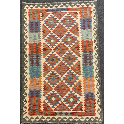 61 - A Turkish Anatolian Kilim rug / carpet, knotted with geometric pattern in red, blue, green and grey,... 