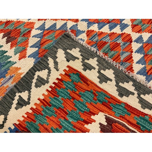 61 - A Turkish Anatolian Kilim rug / carpet, knotted with geometric pattern in red, blue, green and grey,... 