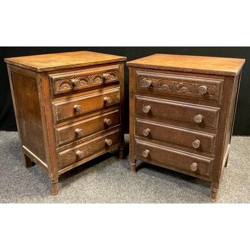 69 - A pair of oak bedside chests, each with four drawers, carved top drawer panel, turned legs, 77cm hig... 