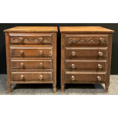 69 - A pair of oak bedside chests, each with four drawers, carved top drawer panel, turned legs, 77cm hig... 