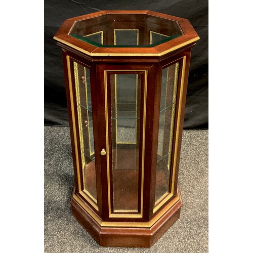 73 - A mahogany octagonal-form Vitrine cabinet, floor-standing, glazed top and sides, two tiers of glass ... 