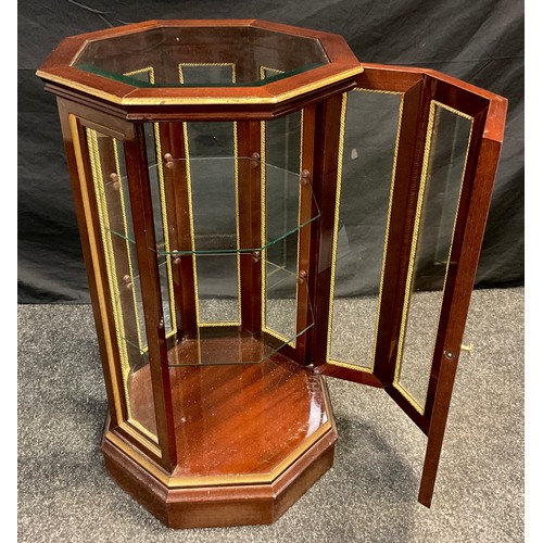 73 - A mahogany octagonal-form Vitrine cabinet, floor-standing, glazed top and sides, two tiers of glass ... 