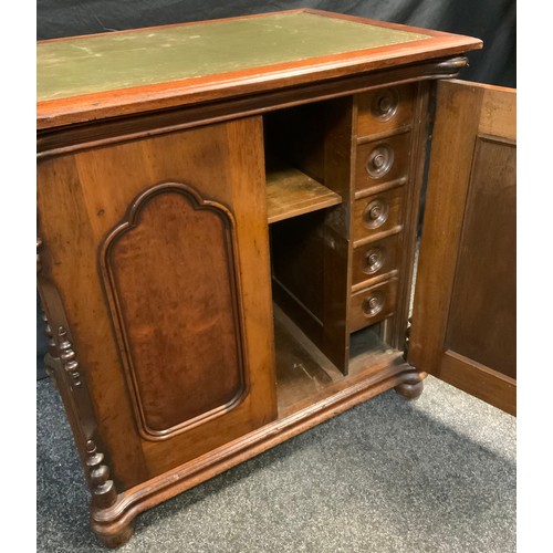 81 - A Victorian mahogany side cabinet, over-sailing rectangular top with green leather writing surface, ... 