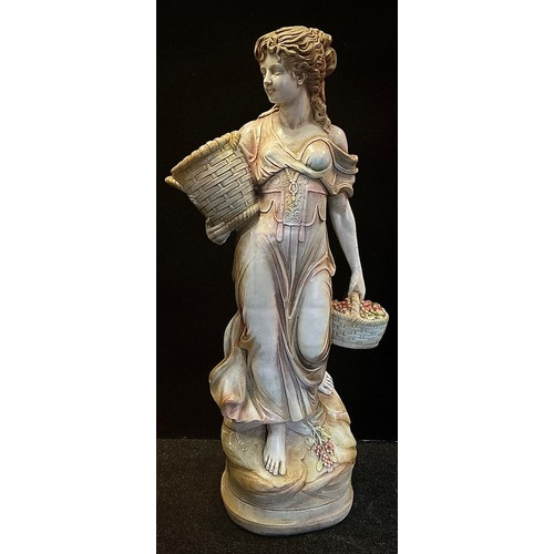 86 - A glazed and painted figural statue, as a classical maiden, a planter basket to her arm, 136cm high