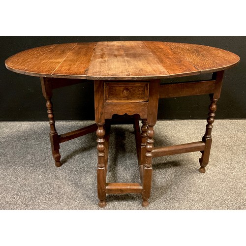 94 - A George III oak gate-leg table, oval top, single drawer to frieze, turned supports, 71.5cm high x 9... 