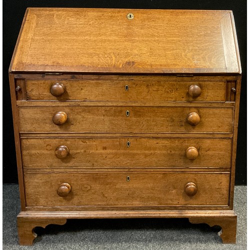 116 - A George III oak bureau, hinged fall top enclosing fitted interior, over four graduated long drawers... 