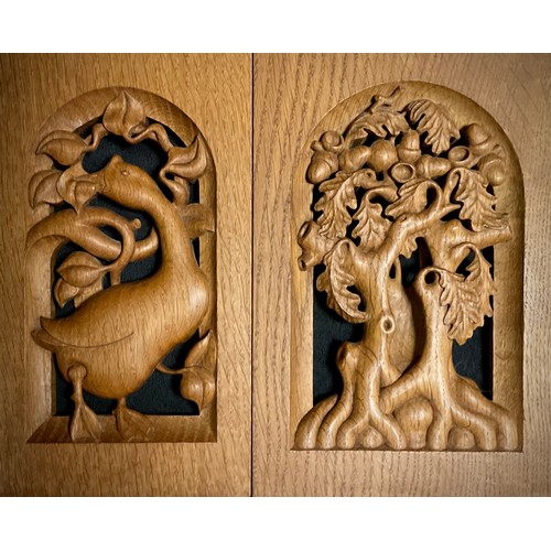 194 - Treen - a pair of carved oak decorative panels, by Roger Sutton, one carved with a fruiting oak tree... 