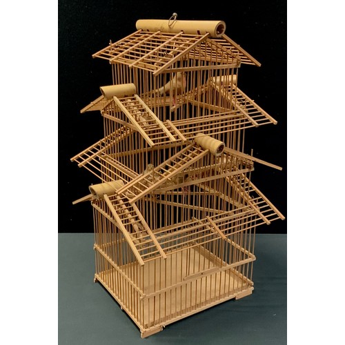 22 - A French wooden pagoda style bird cage, three tiers with three replica birds, 65cm high, 39cm wide, ... 