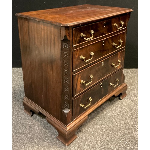 116A - A George III style reproduction mahogany chest of drawers, over-sailing canted rectangular top, carv... 