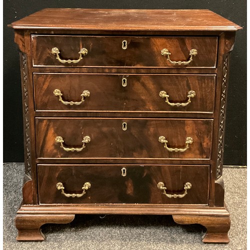 116A - A George III style reproduction mahogany chest of drawers, over-sailing canted rectangular top, carv... 