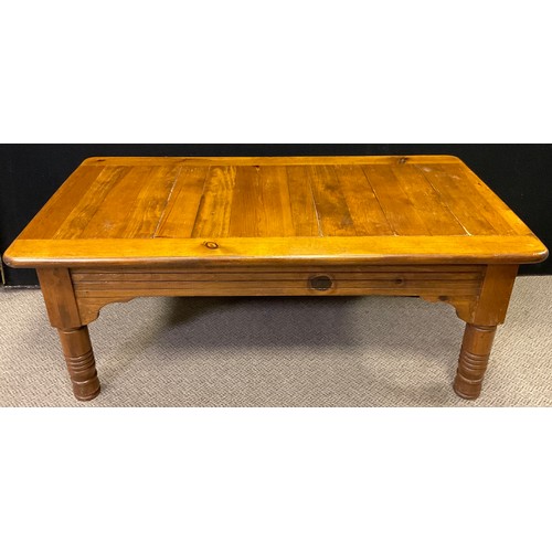 294 - A contemporary pine coffee table, rounded rectangular top, turned legs, 48cm high x 120cm x 65cm;  a... 