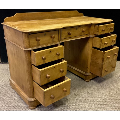 341 - A pine pedestal desk, quarter-galleried top with break-centre shaped front and three drawers to frie... 