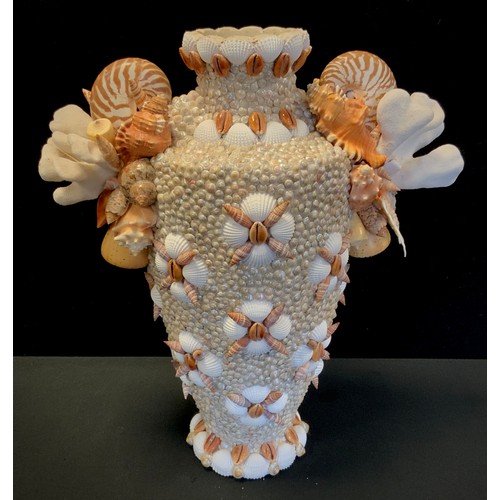 73A - Laura Gonzalez - a hand embellised Coral and shells encrusted vase, all over decorated with assorted... 