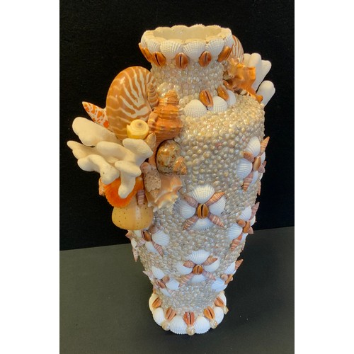 73A - Laura Gonzalez - a hand embellised Coral and shells encrusted vase, all over decorated with assorted... 