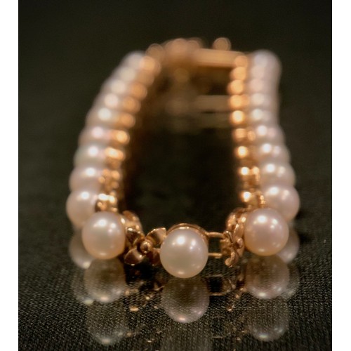 514 - A 9ct gold cultured pearl and floral link bracelet, stamped 375, 10k, Qvc, 8.2g gross