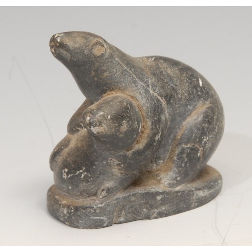 15 - An Inuit soapstone carving, of a hunter and a seal, 21cm long, label for Canadian Inuit Art, mid 20t... 