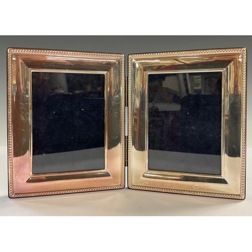 28 - An Elizabeth II silver diptych double photograph frame, Sheffield 1998