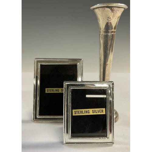 30 - An Elizabeth II silver specimen vase, Birmingham 1977; two small silver easel photograph frames (3)