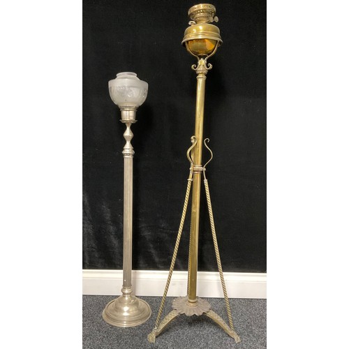 61 - A brass lamp stand with Duplex burners and a tripod base, each terminating with a mask; a steel cand... 