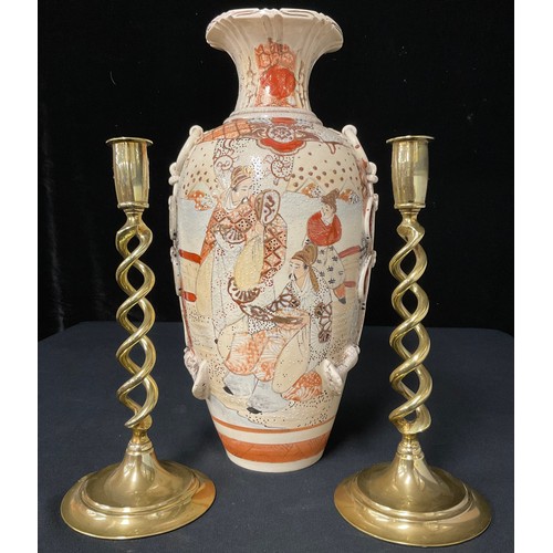 83 - A Japanese Satsuma type export ware vase, c.1900; a pair of brass open barley twist candlesticks (3)