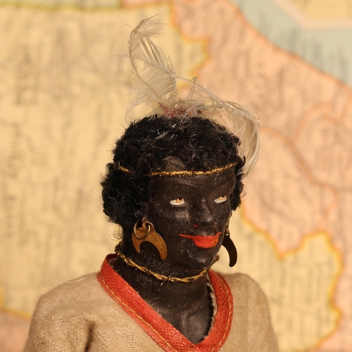 125 - An early 20th century black composition jointed doll, painted features, black flock type hair, 20cm ... 