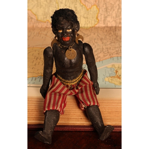 126 - An early 20th century black composition jointed doll, painted features, black flock type hair, 18cm ... 