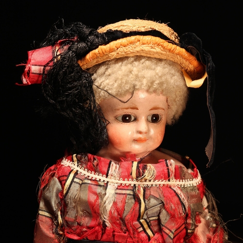 131 - A 19th century painted papier-mâché or composition shoulder head doll, the papier-mâché or compositi... 