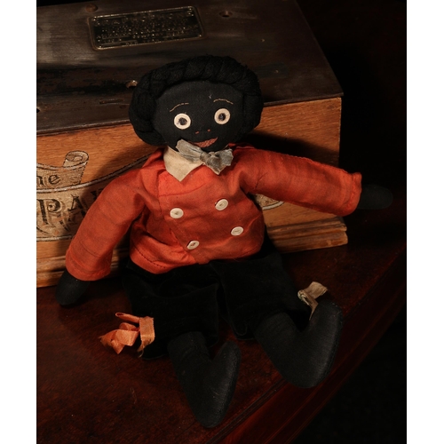 138 - Folk Art - an early 20th century stuffed cloth black doll, the fabric head applied with black and wh... 