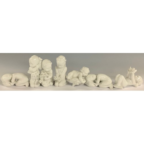 596 - A set of seven Danish Bing and Grøndahl merchildren figures, each glazed in gloss white, in various ... 