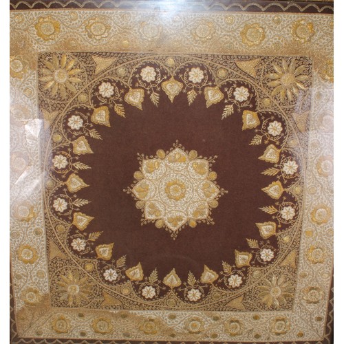 601 - An Indian textile panel, worked in gilt and silvered threads, on a crimson ground, 83cm x 80cm, gilt... 