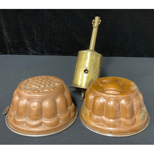 607 - A Victorian brass roasting jack; two copper jelly moulds