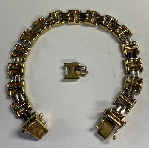 613 - A 9ct gold bracelet, one spare link