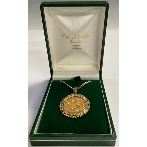 618 - An Edwardian gold sovereign, set in 9ct mount and chain