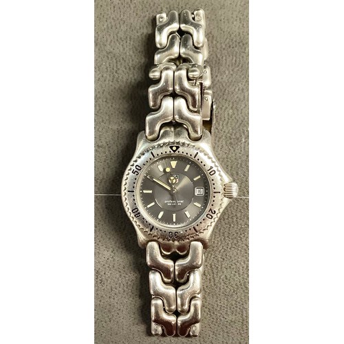 623 - A lady's Tag Heur stainless steel watch, steel grey engine turned dial, baton indicators, centre sec... 