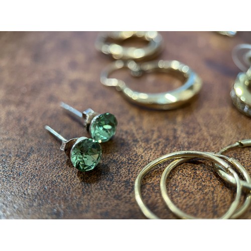 642 - A pair of 9ct gold and diamond ear studs, the two round brilliant cut stones within gold roundels; a... 