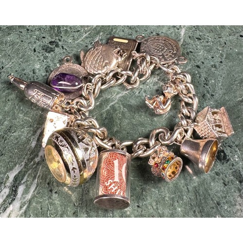 647 - A silver curb link charm bracelet, set with 13 silver charms, silver locket clasp, 79.7g gross (Quan... 