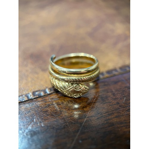 650 - A gold coloured metal snake ring, engraved with chevrons forming the snakes skin, probably 9ct gold,... 