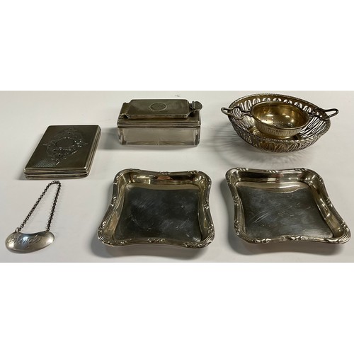 679 - A silver circular sweetmeat dish, Birmingham 1934; a silver tea strainer; a silver decanter label; a... 