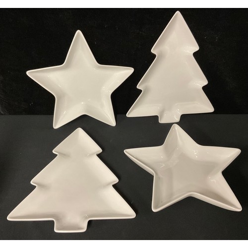 687 - A pair of Christmas tree shaped serving plates, 29cm; a similar pair of star shaped serving/party pl... 