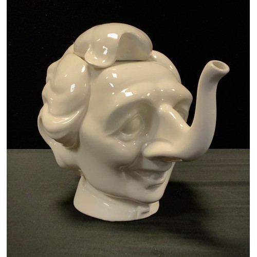 11 - A Luck & Flaw white glazed teapot and cover in the form of Margaret Thatcher, impressed factory mark... 