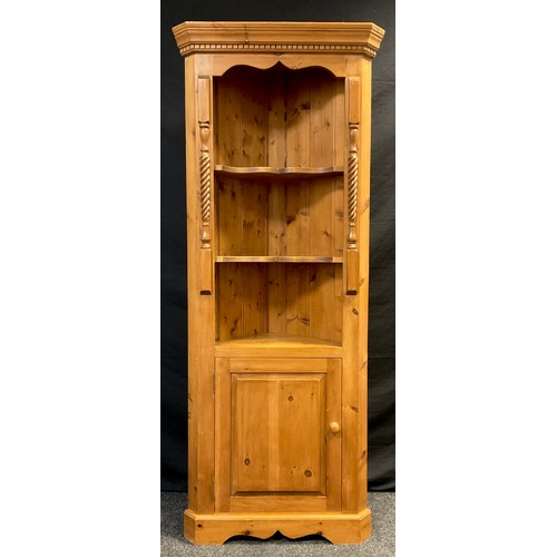 21 - A Pine corner cupboard / shelving unit, dentil cornice above two-tiers of serpentine shaped shelving... 