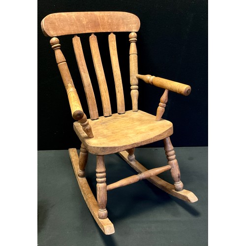 33 - An early 20th century elm children's rocking chair, 70cm x 42cm x 47cm